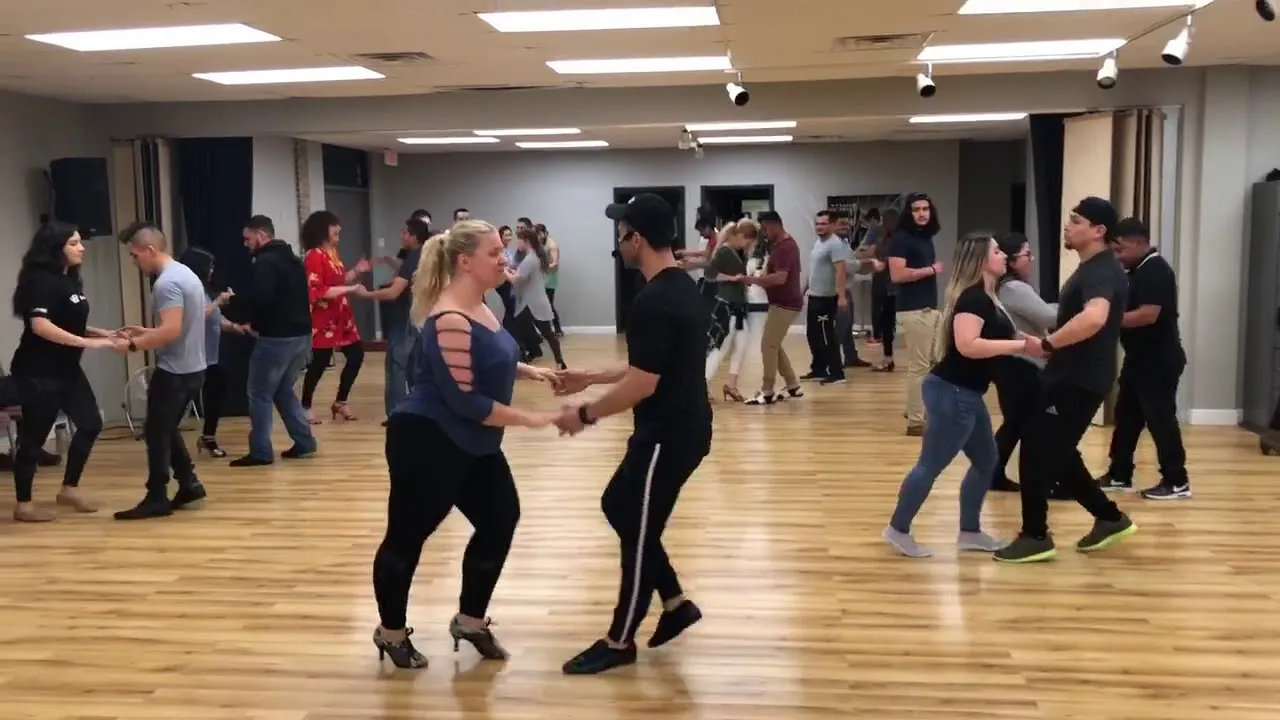 Students working through a step together in a group class